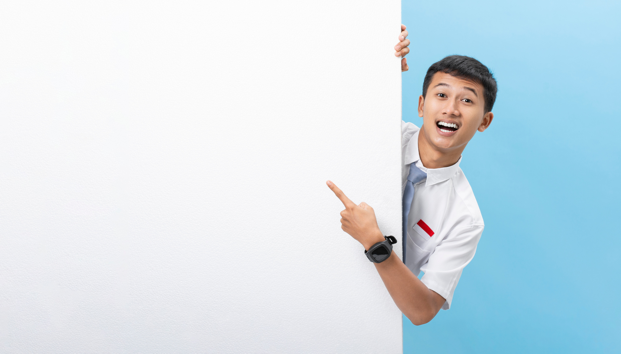 Indonesia high school student behind white wall blank space